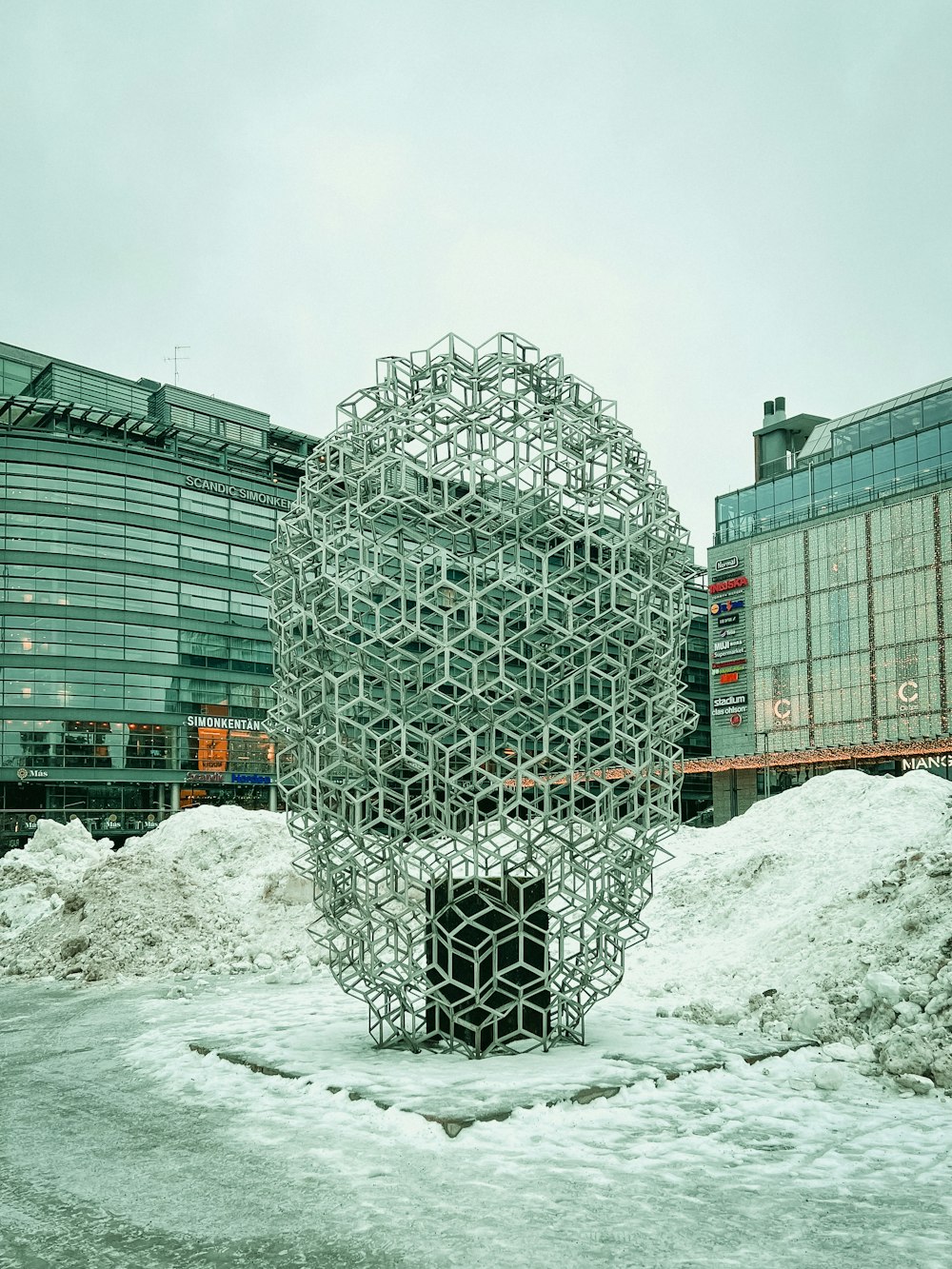 a sculpture in the middle of a pile of snow