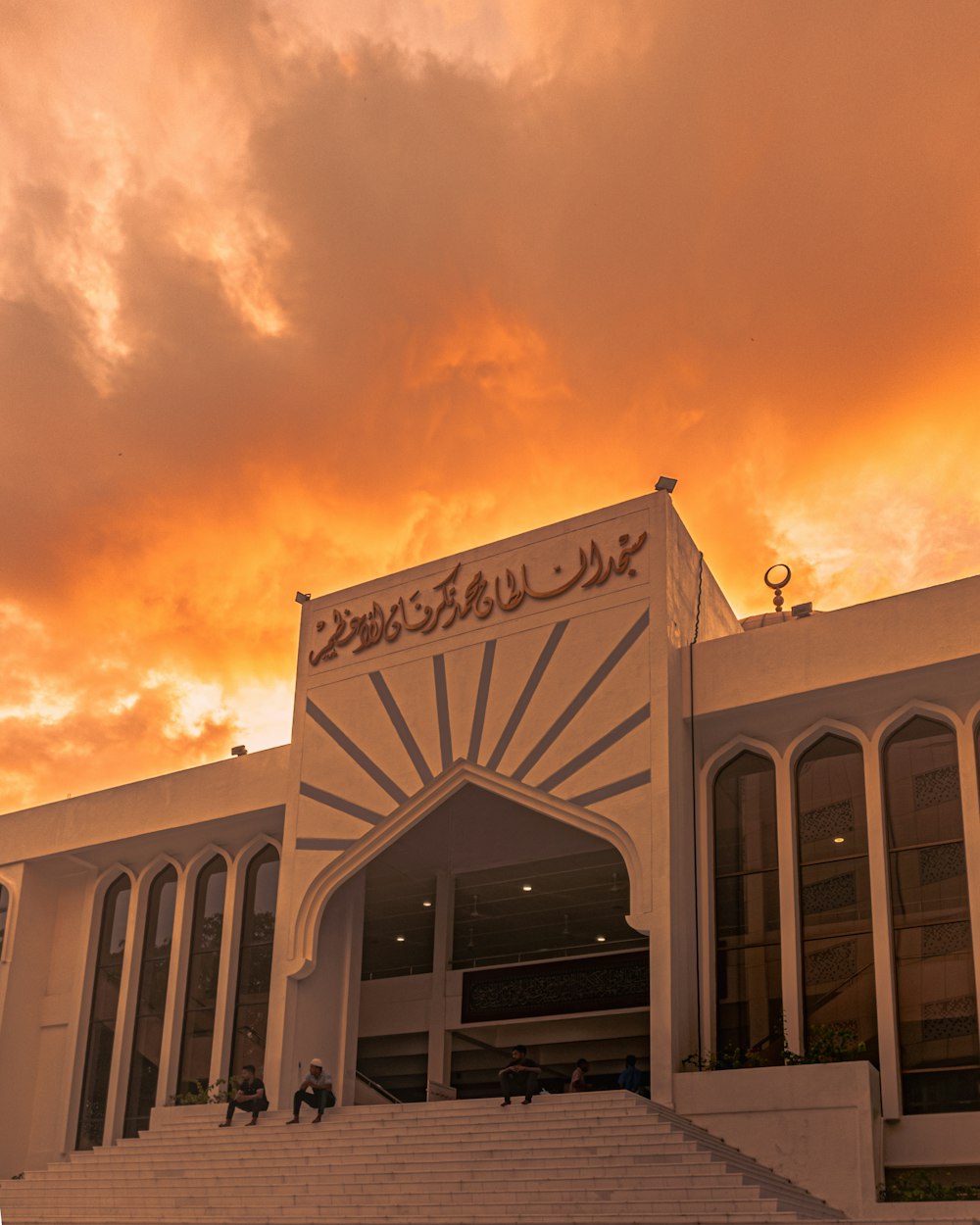 a building with a staircase leading up to it under a cloudy sky