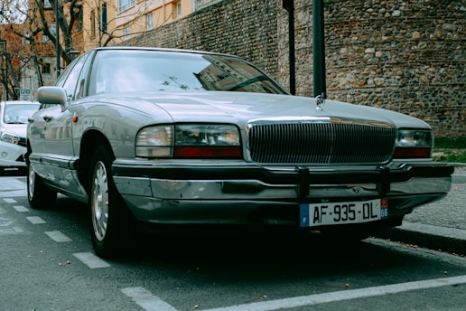 a silver car parked on the side of the road