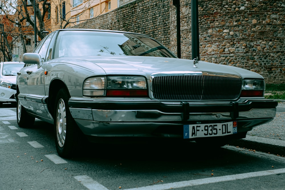 a silver car parked on the side of the road