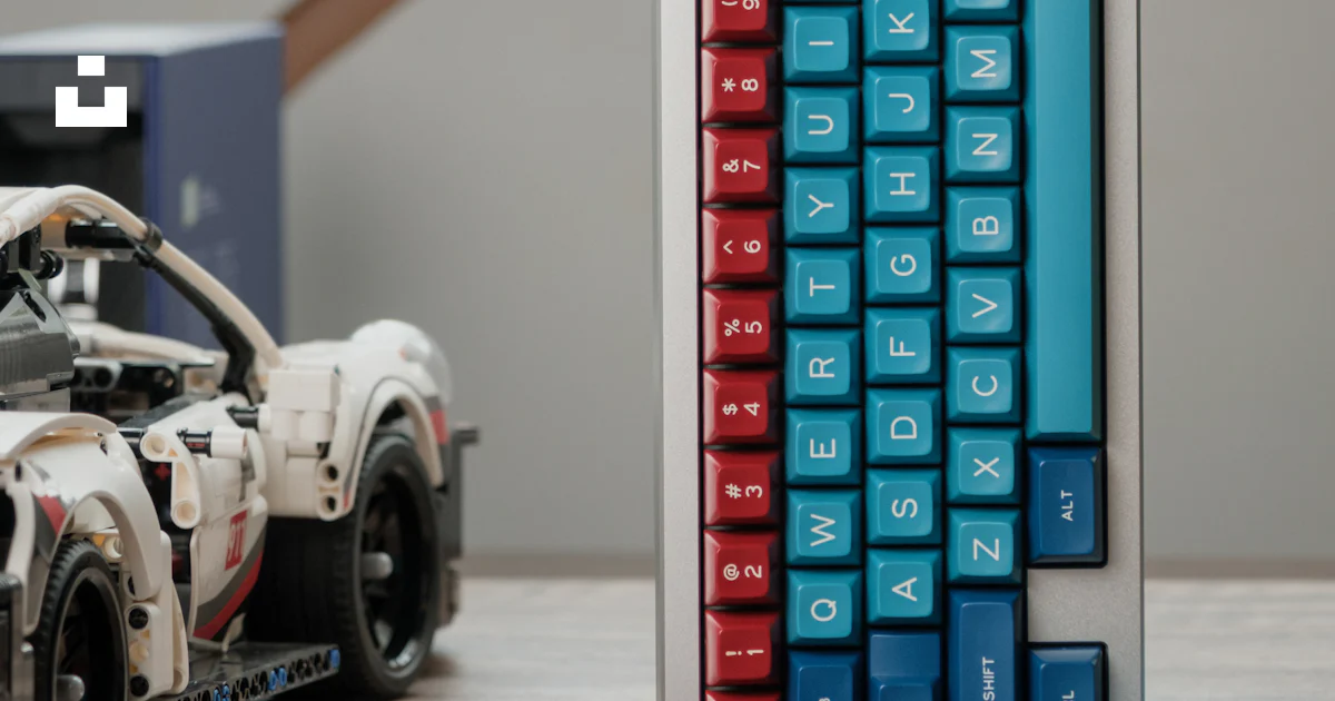 Camaro Computer Keyboard A toy car and a computer keyboard on a table photo – Free Keyboard ...