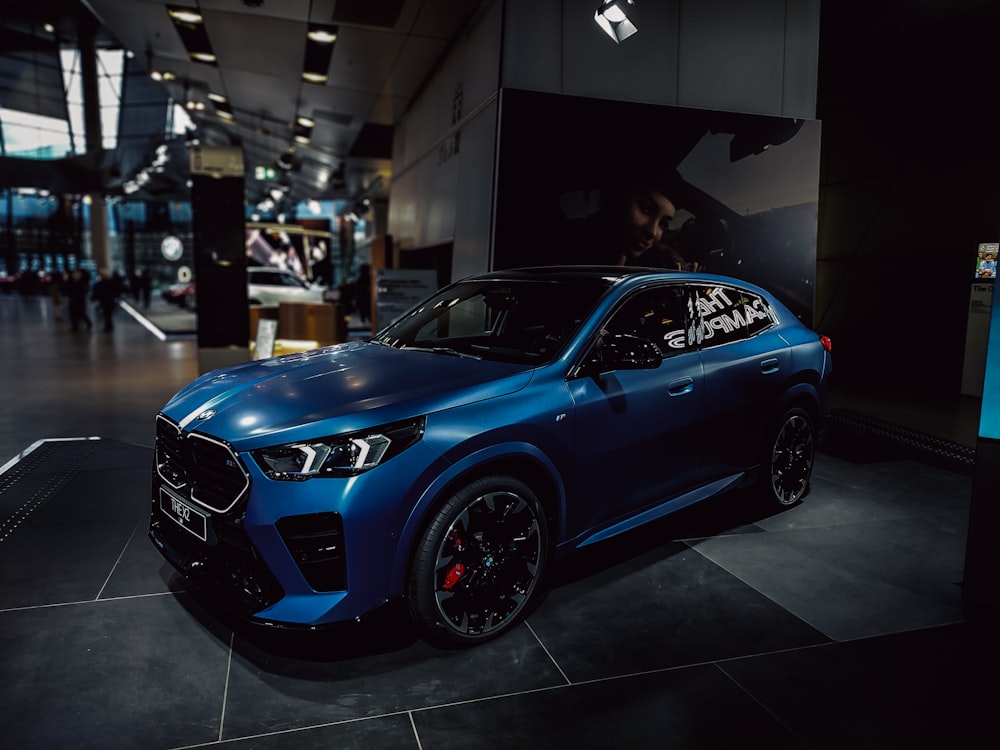 a blue suv parked inside of a building