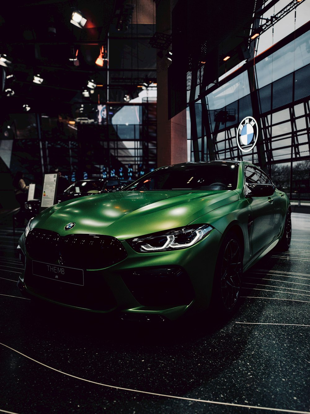 a green sports car parked in a garage