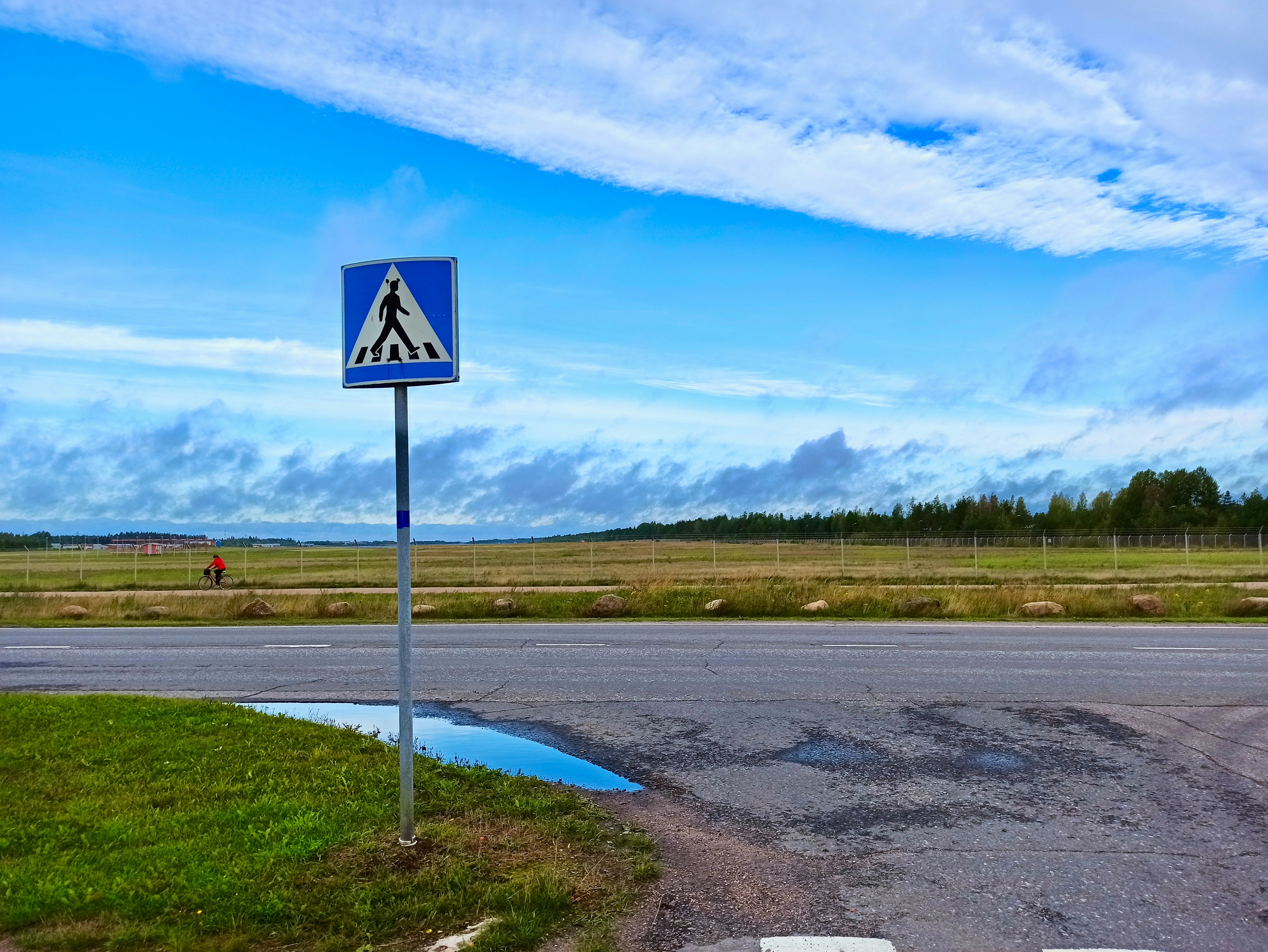 a blue sign sitting on the side of a road