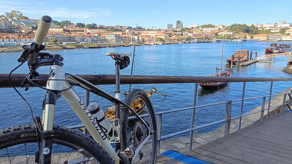 a bicycle is parked on a bridge over a body of water
