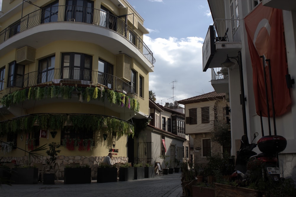 a city street with buildings and a clock tower in the background