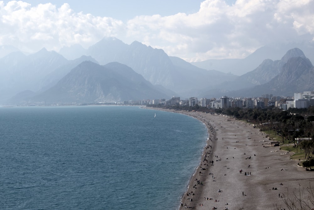 a view of a beach with mountains in the background