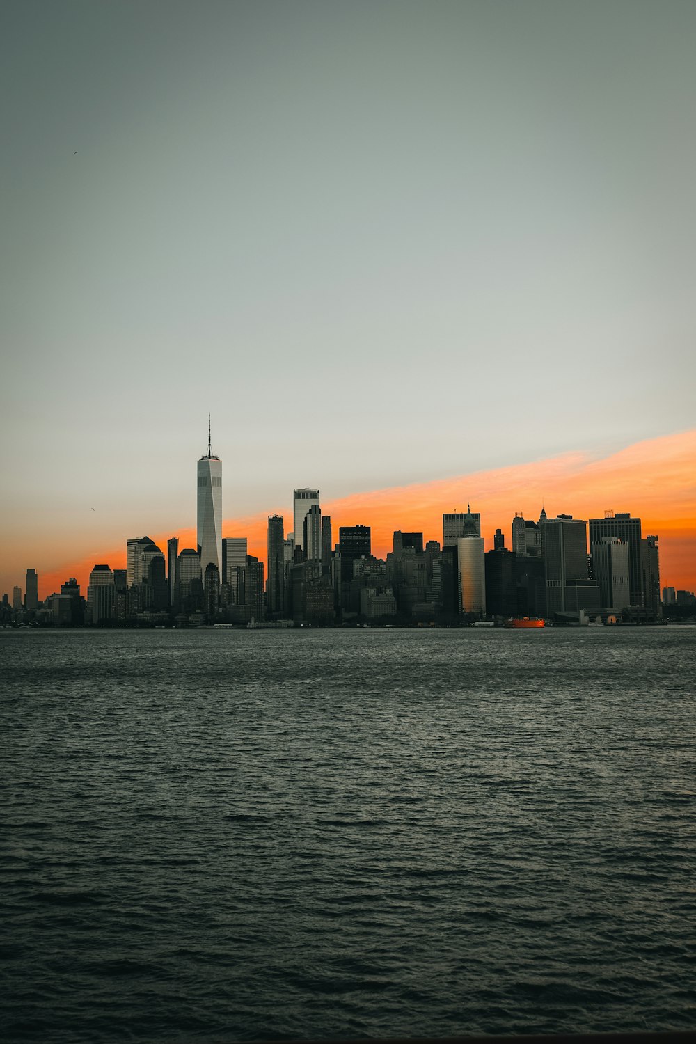 a large body of water with a city in the background