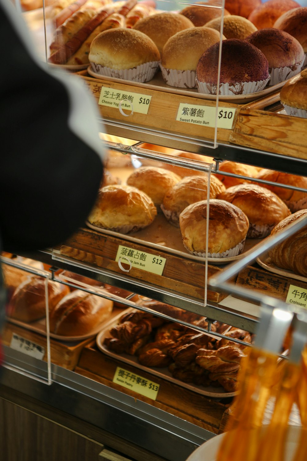 a display case filled with lots of different types of bread