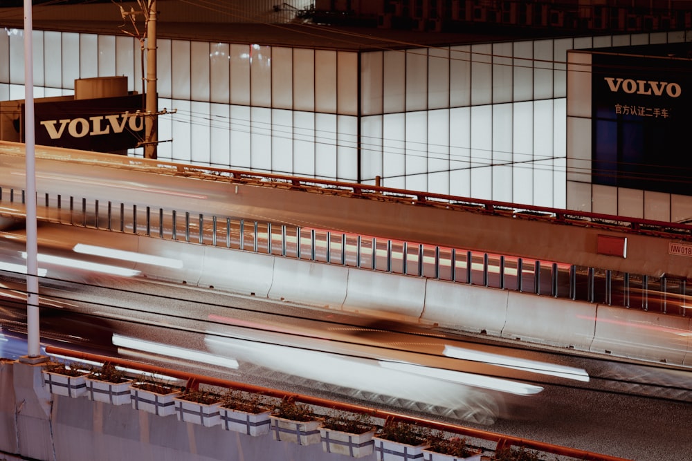 a train traveling through a train station next to a tall building