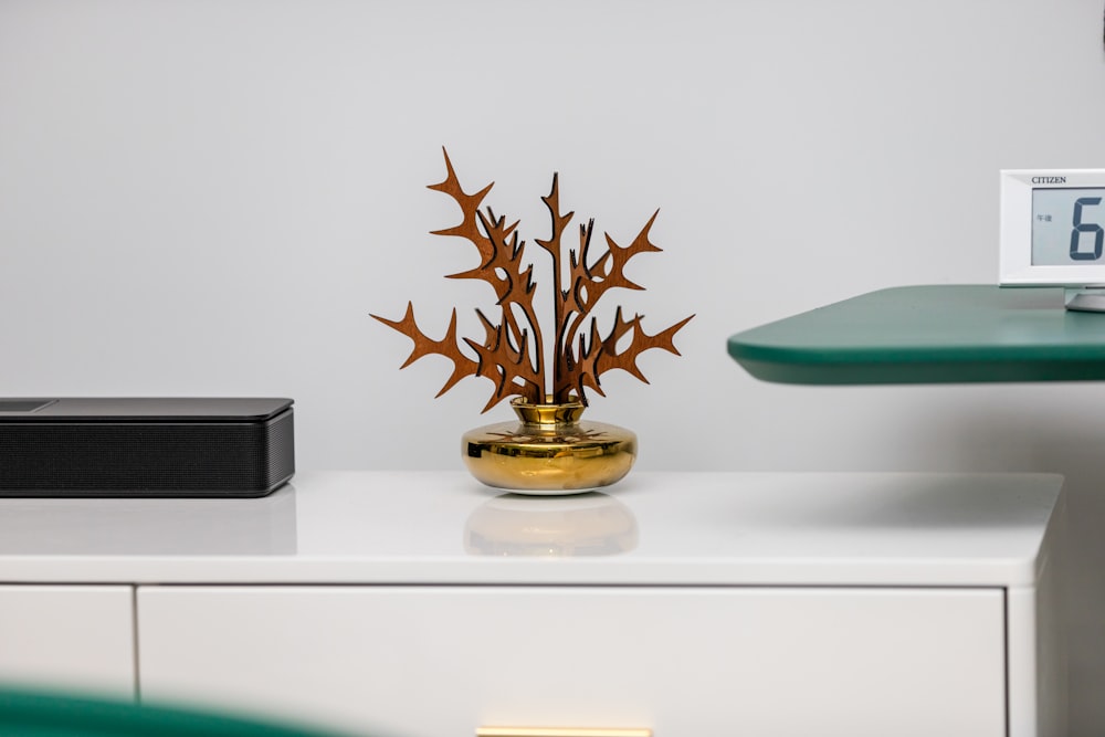 a table with a clock and a plant on it