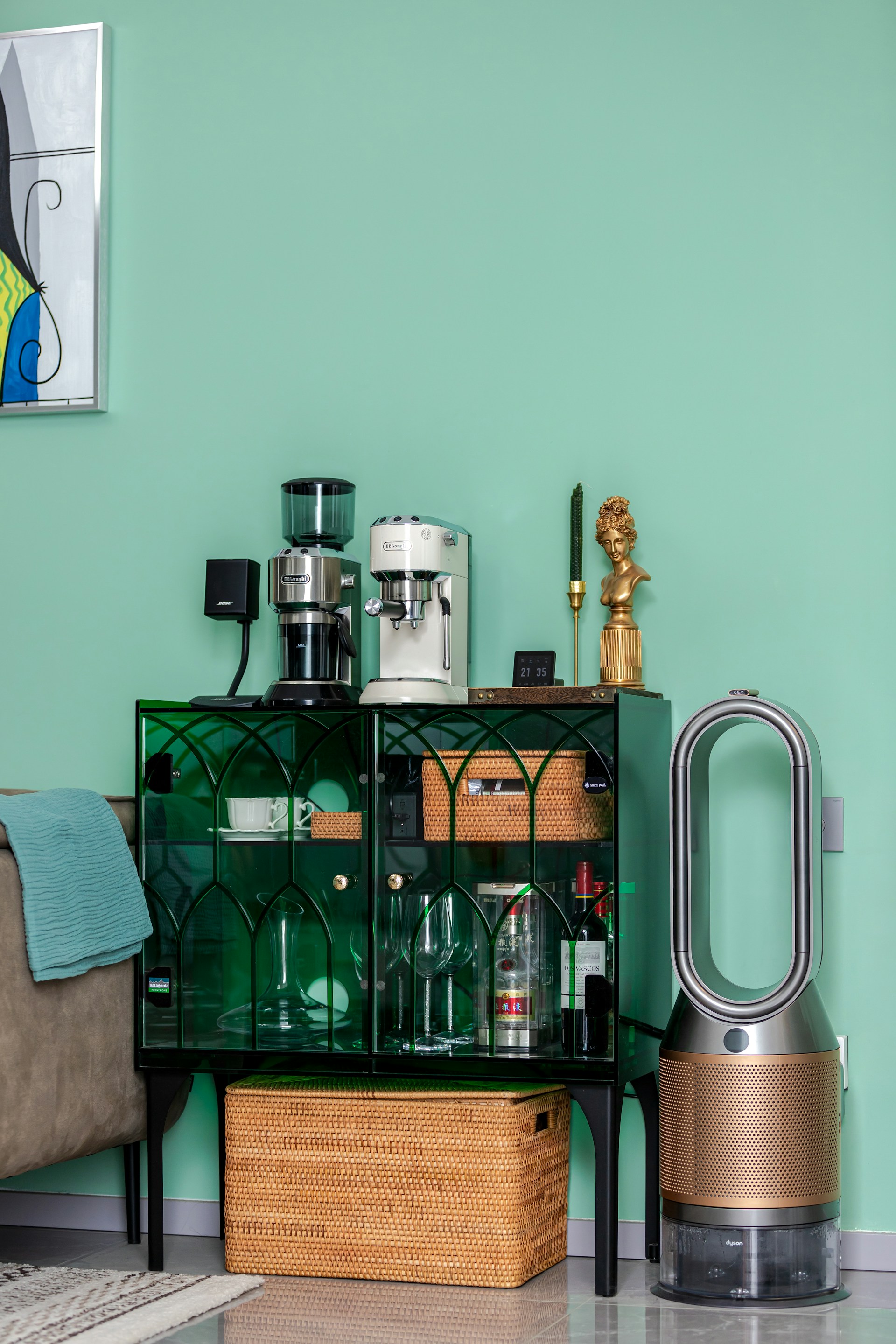 a living room with a green wall and furniture