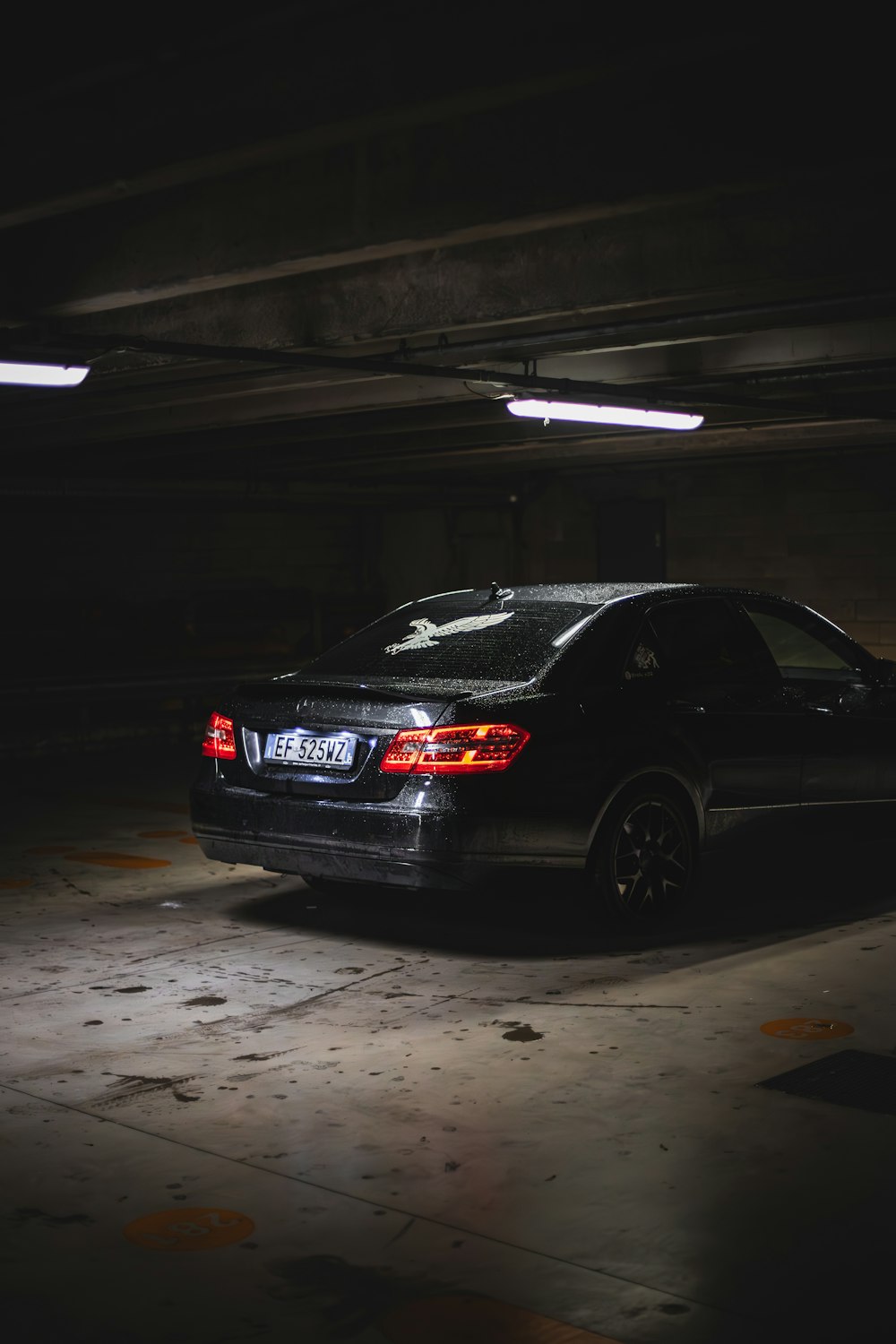 a car parked in a parking garage at night