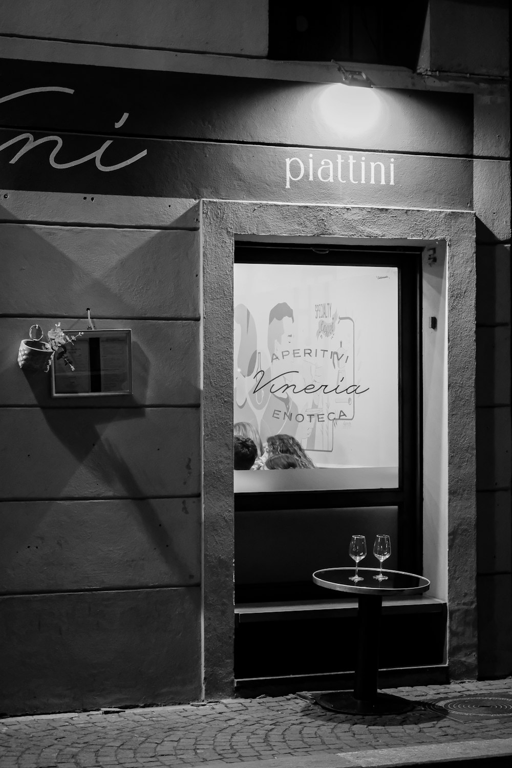 a black and white photo of a restaurant entrance