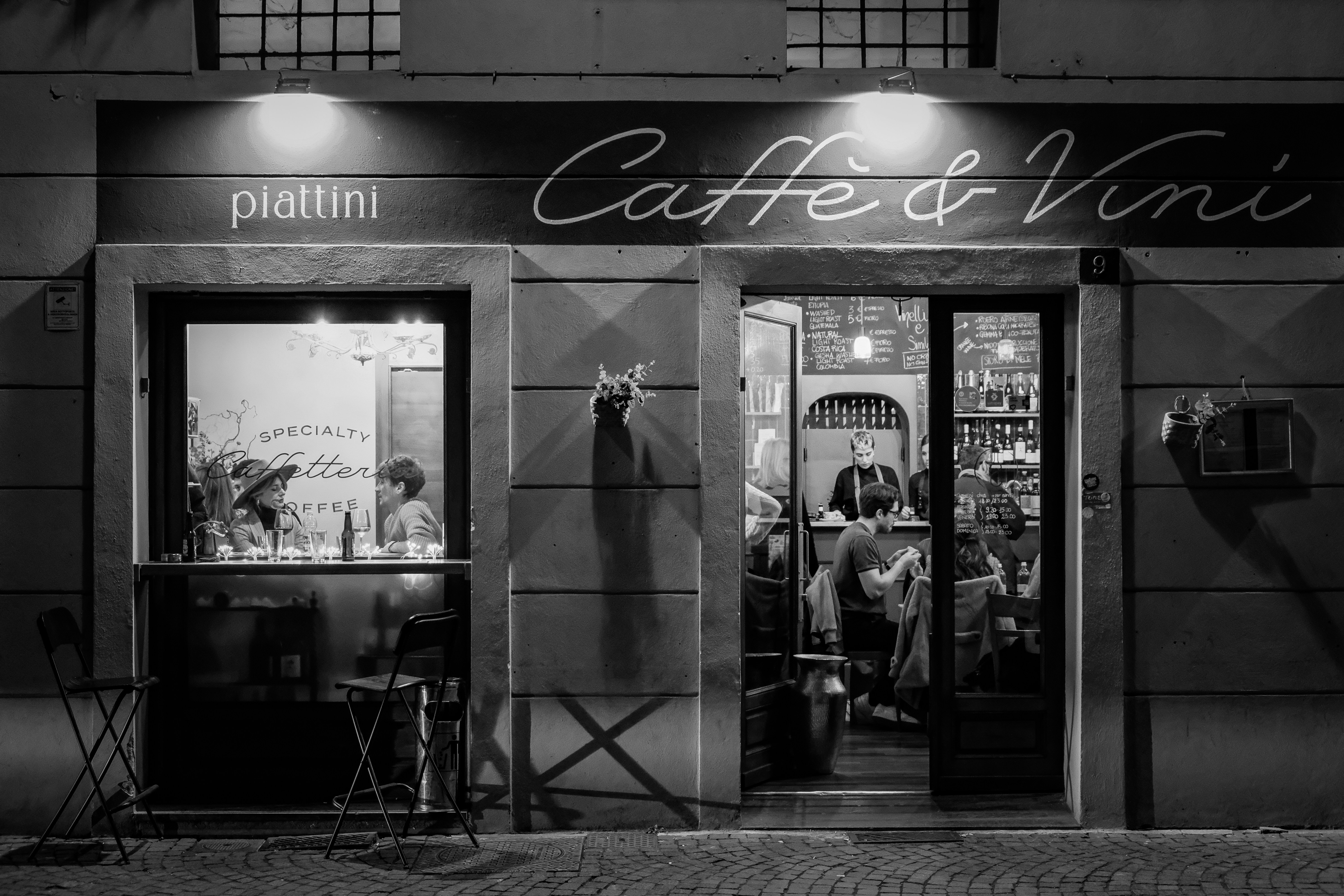 a black and white photo of a coffee shop