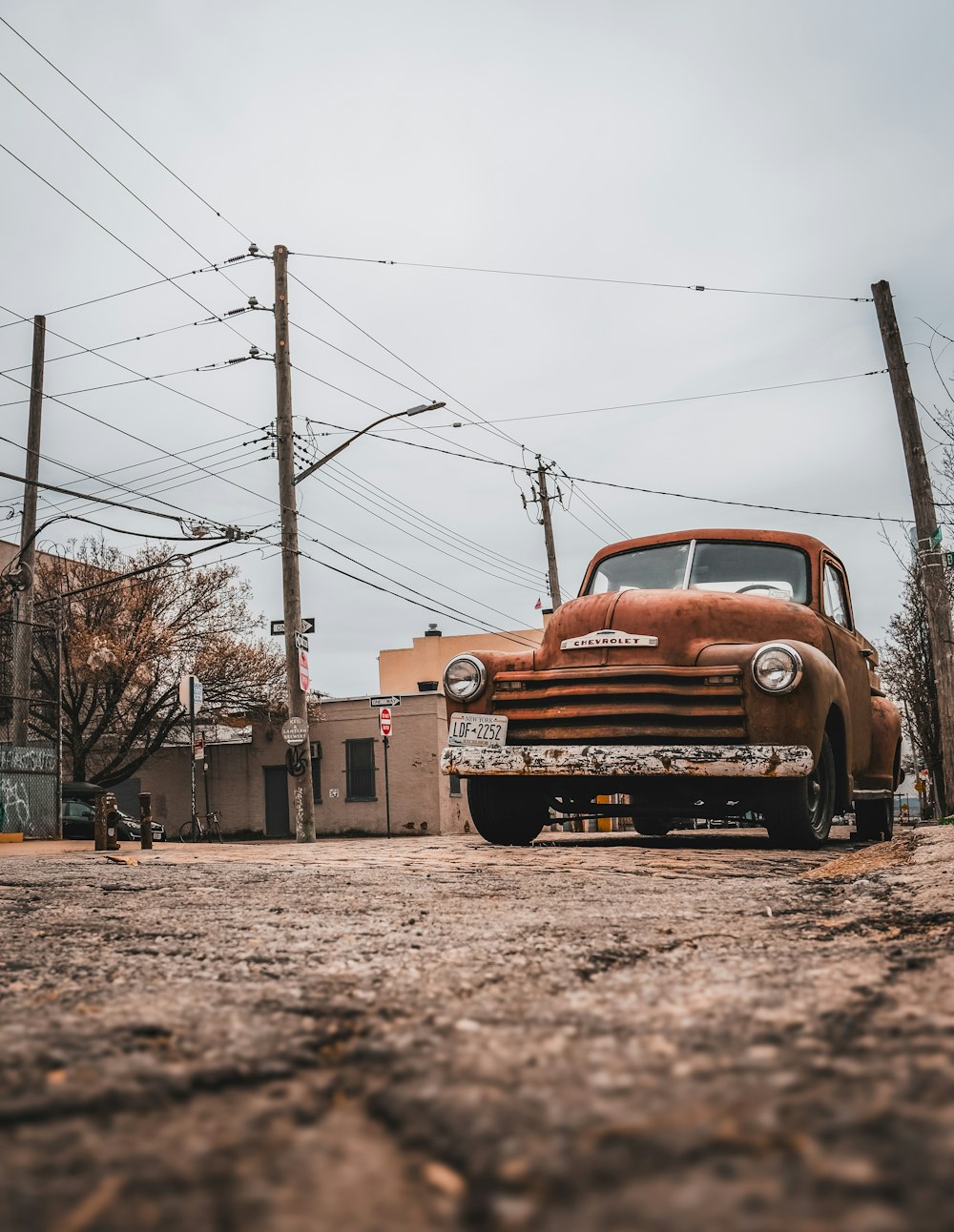 an old truck parked on the side of the road