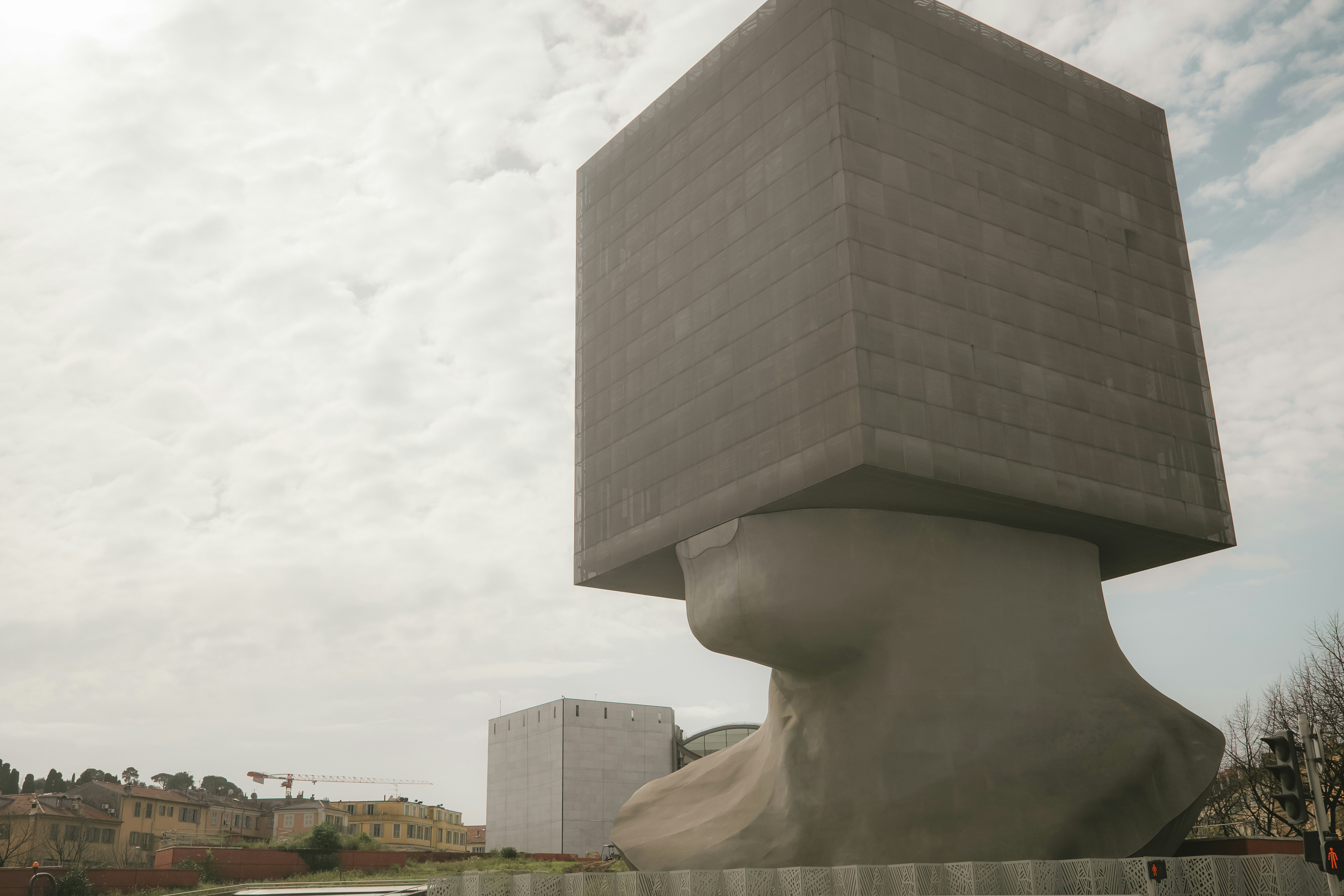 a sculpture of a cube on top of a building