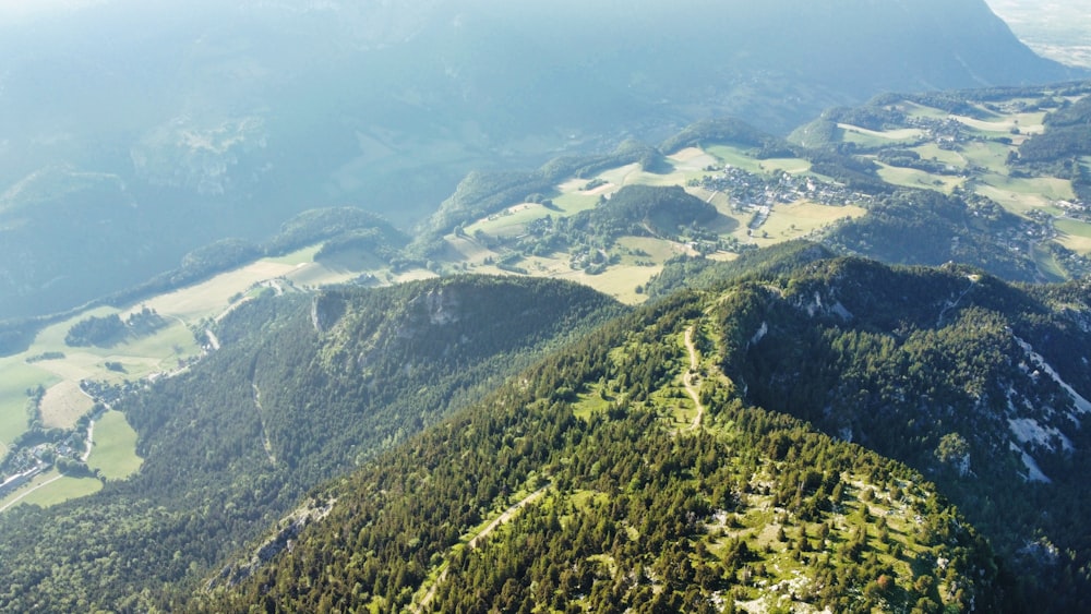 a view from a plane of a valley and mountains