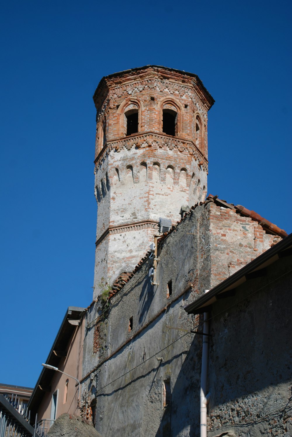 a tall brick building with a clock on it's side