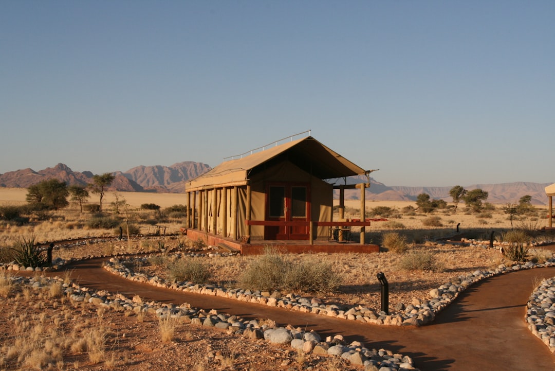 a small building in the middle of a desert,