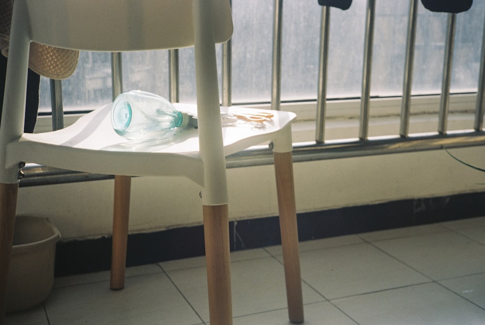 a white chair sitting in front of a window