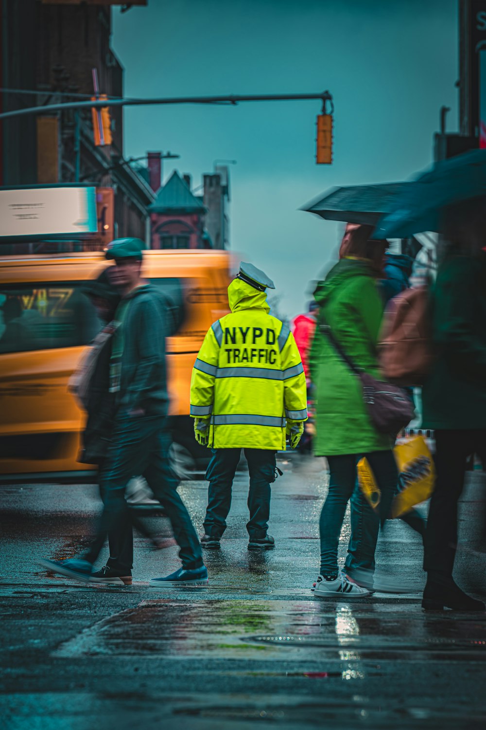 a group of people walking across a street holding umbrellas