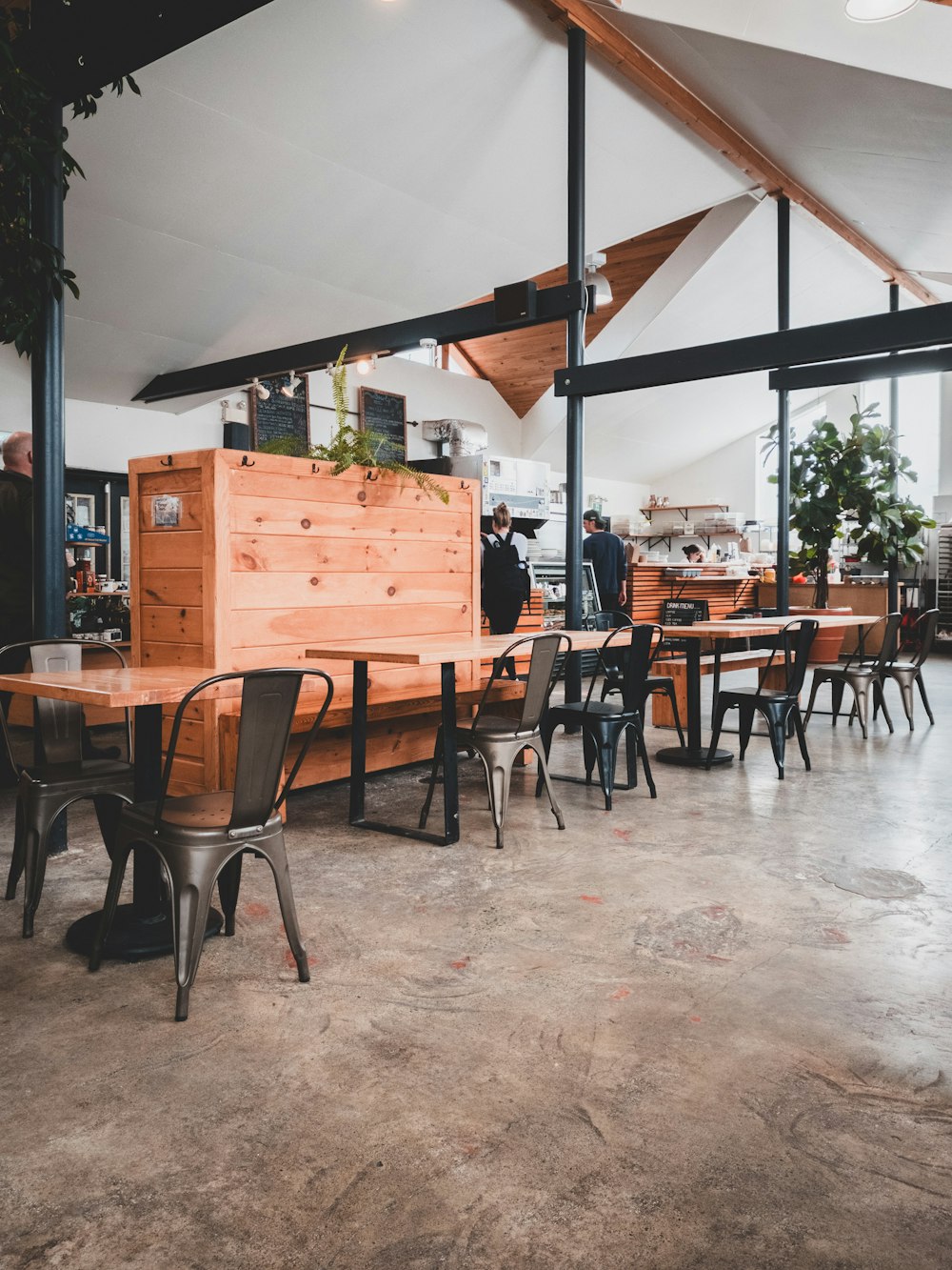 a restaurant with tables, chairs and a counter