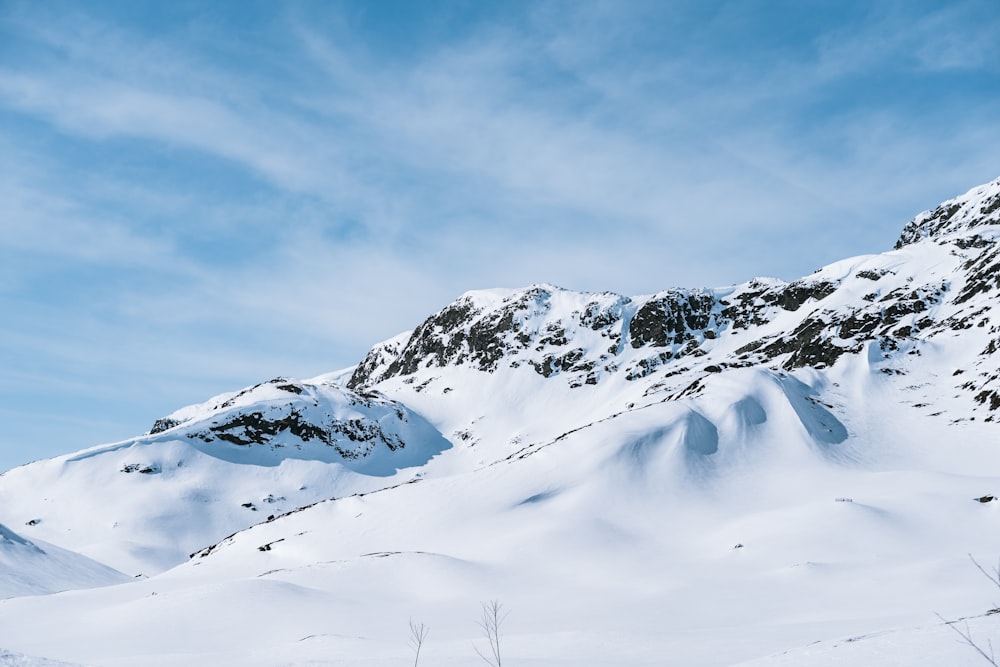 a mountain covered in snow under a blue sky