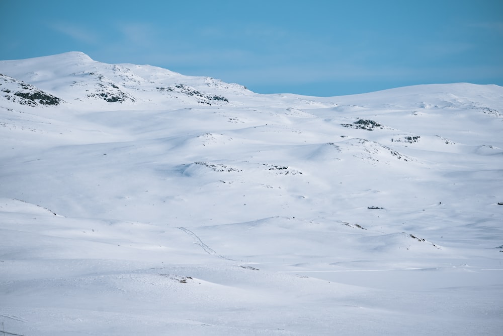 a man riding skis down a snow covered slope