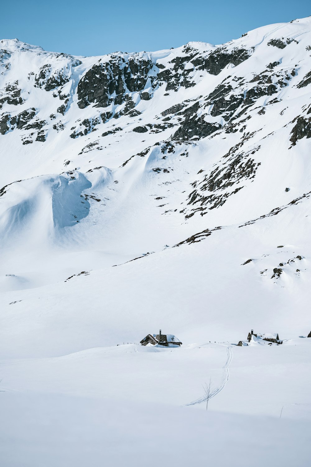 a man riding skis down a snow covered slope