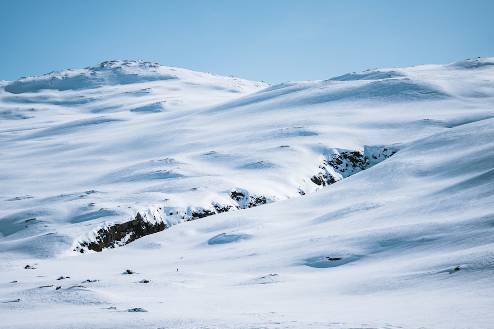 a person riding skis down a snow covered slope