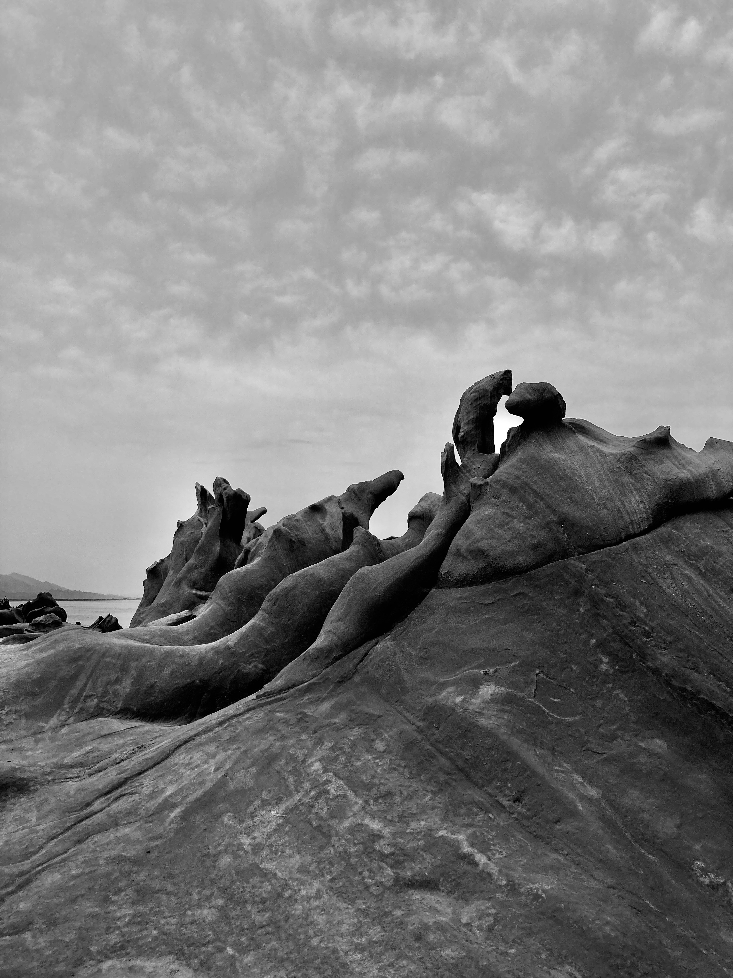 a black and white photo of a rock formation