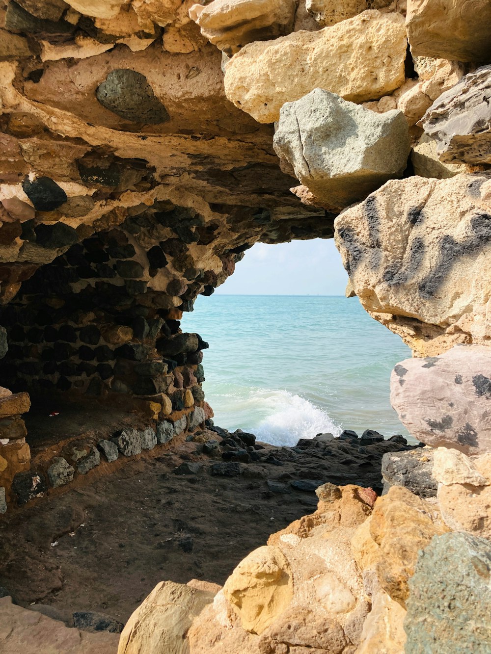 a view of the ocean from inside a cave