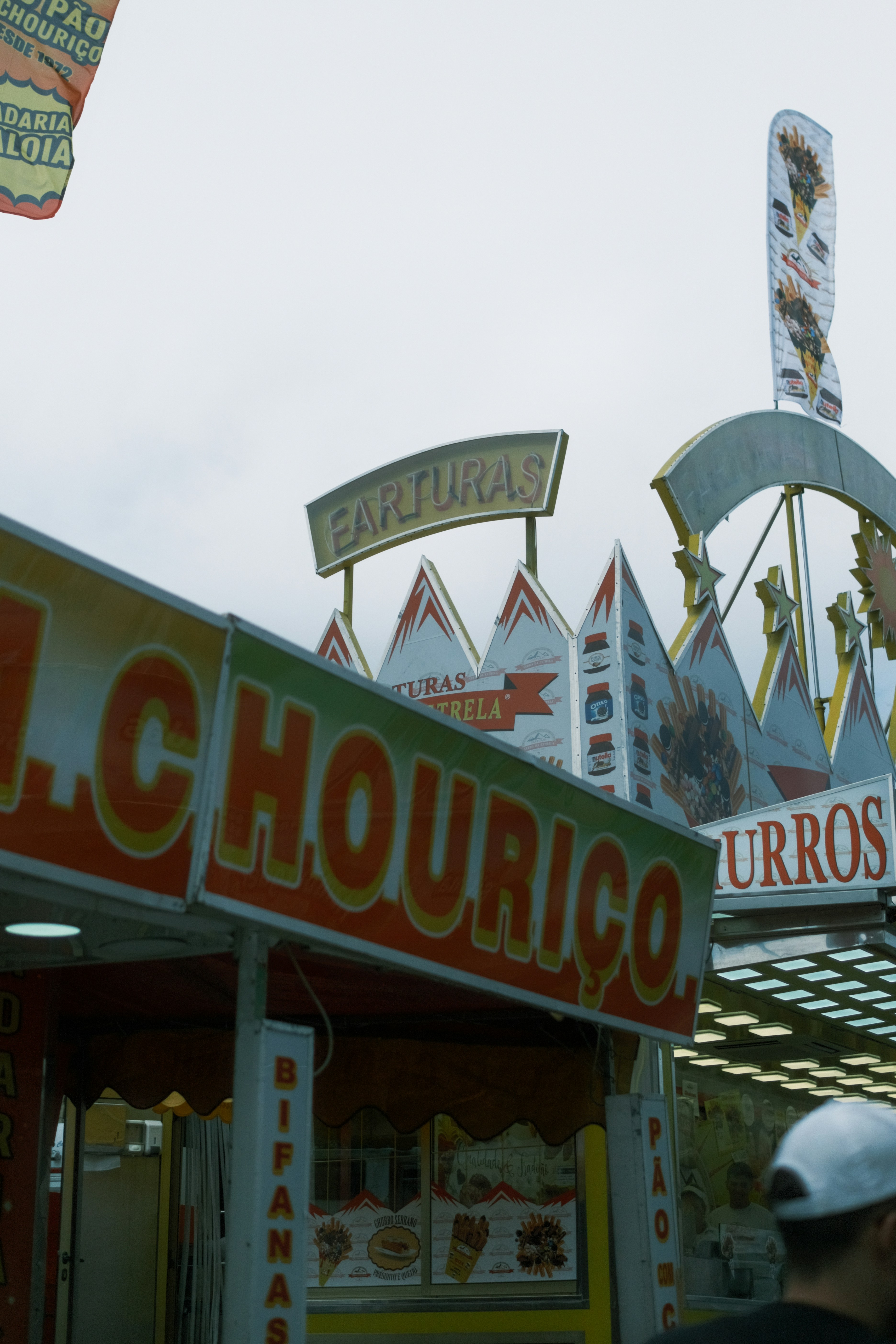 a group of people standing outside of a carnival