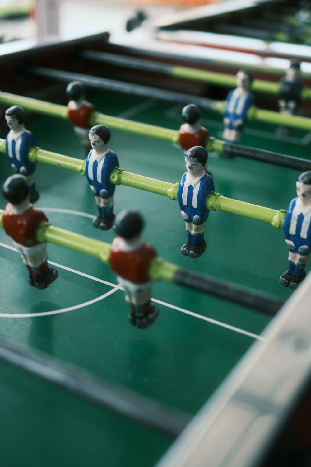 a close up of a foosball table with foosball players