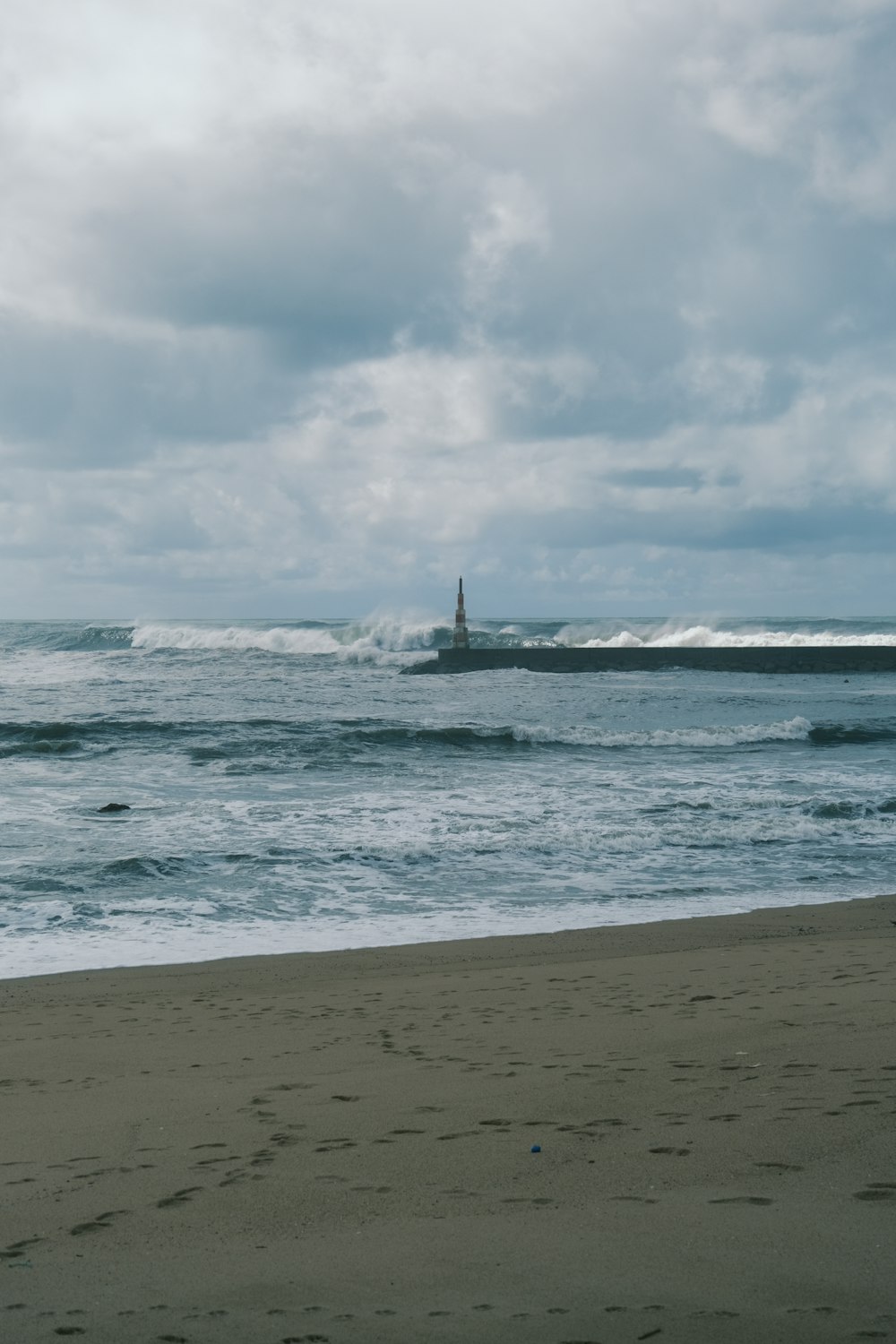 a person walking on a beach near the ocean