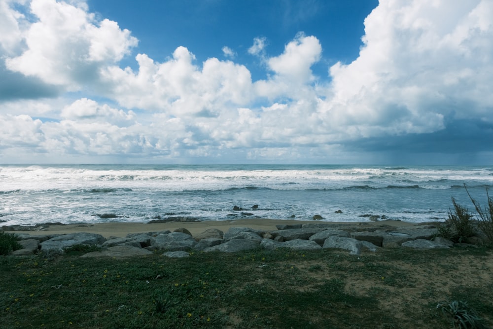 a view of the ocean from a rocky shore