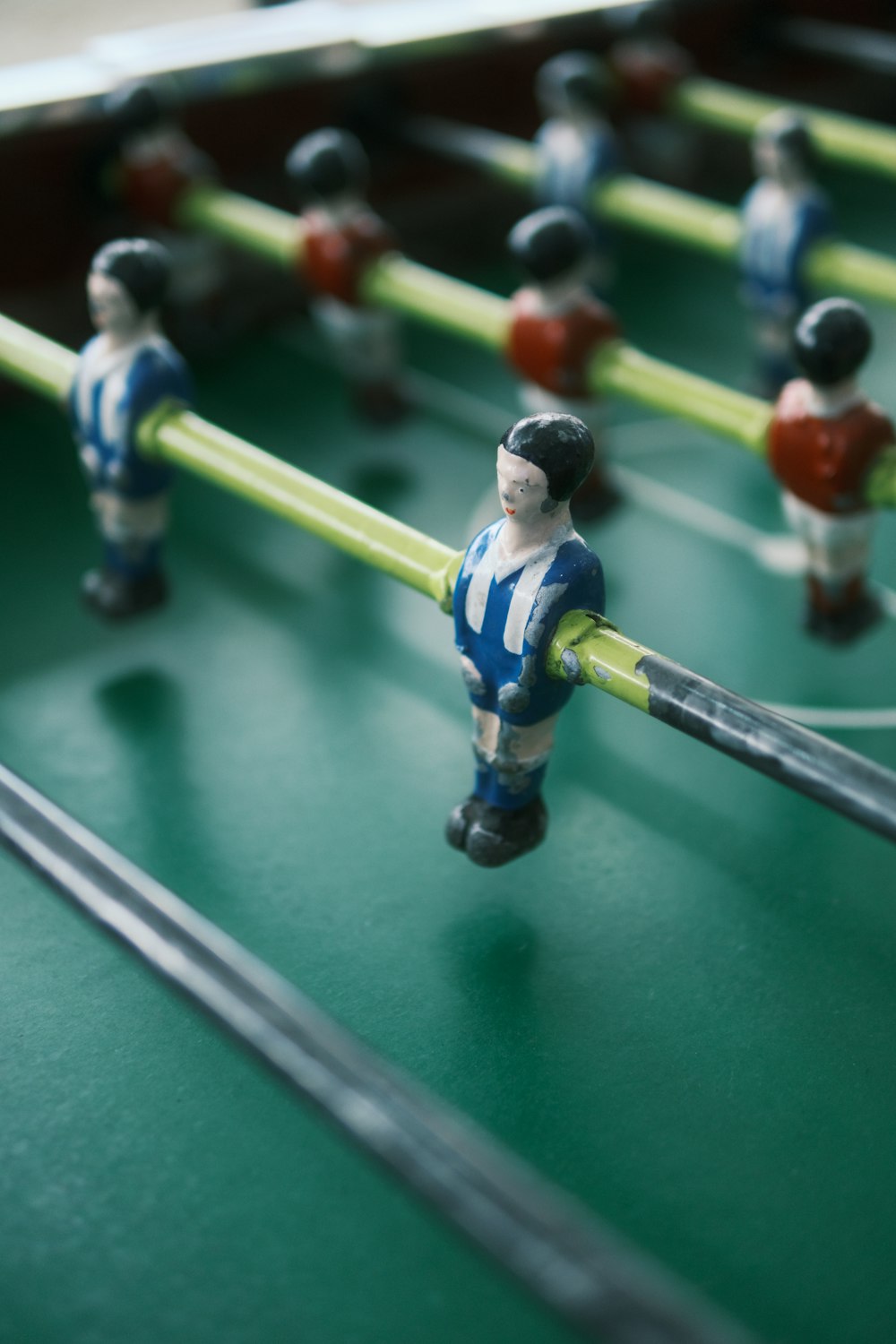 a close up of a foosball table with foosball players