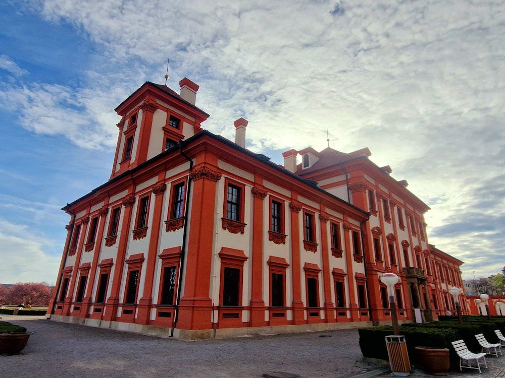 a large red and white building with a clock tower