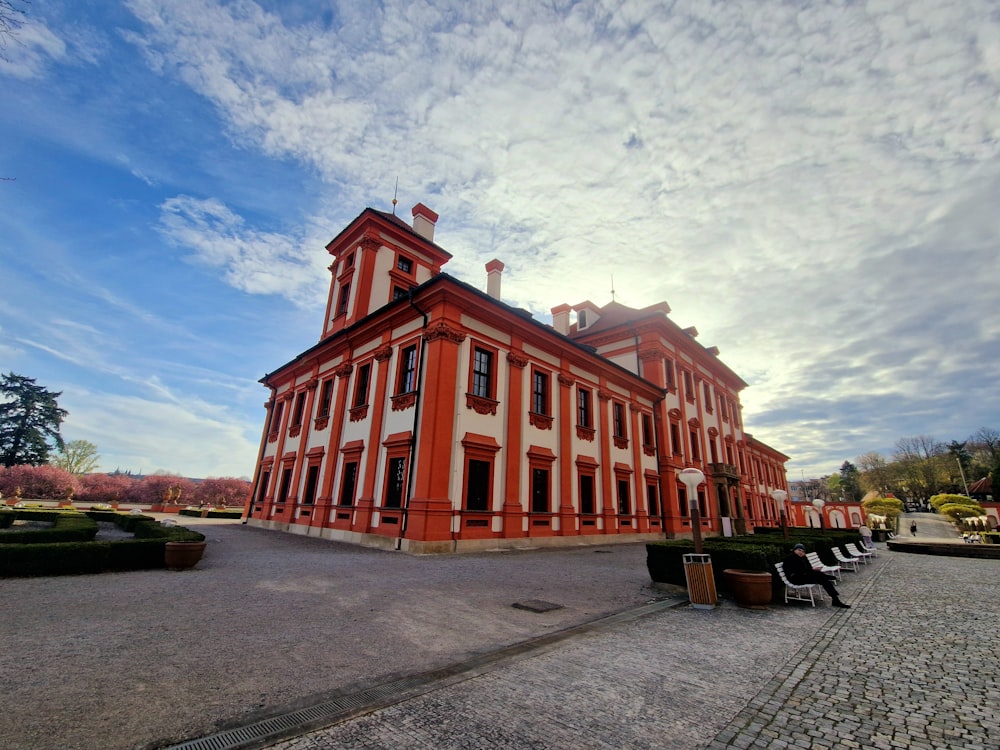 a large red and white building sitting on the side of a road