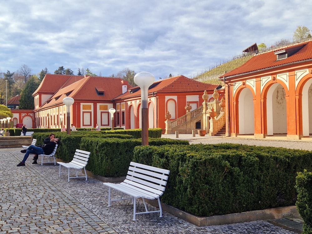 a person sitting on a bench in front of a building