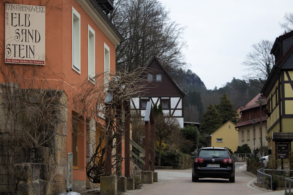 a car is parked on a cobblestone street