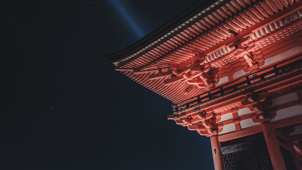 a tall red building with a light on top of it