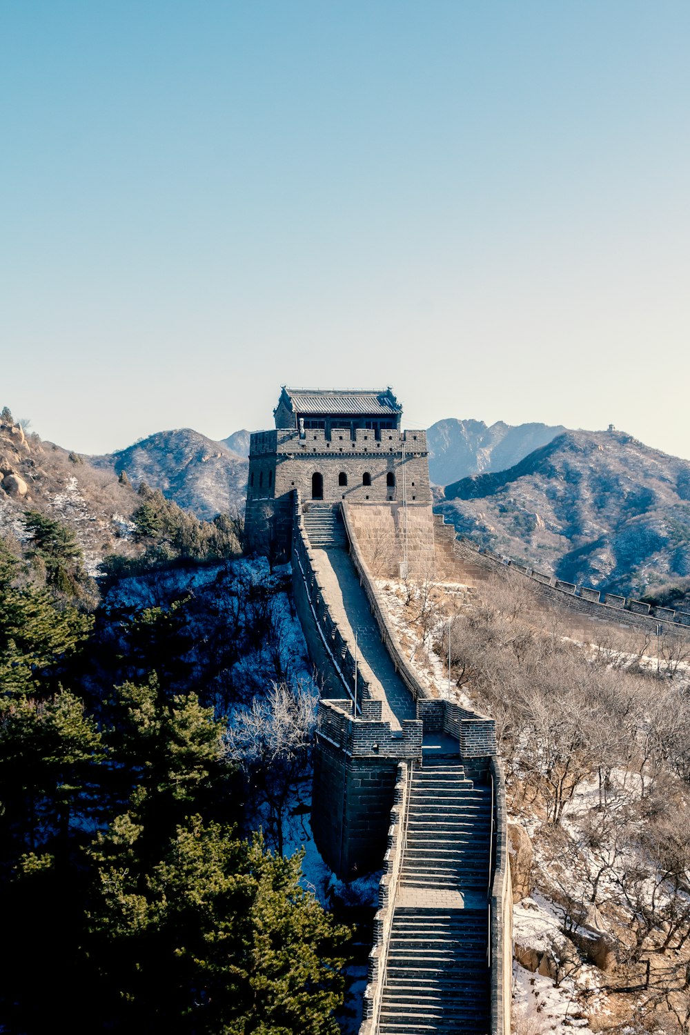 the great wall of china with snow on the ground