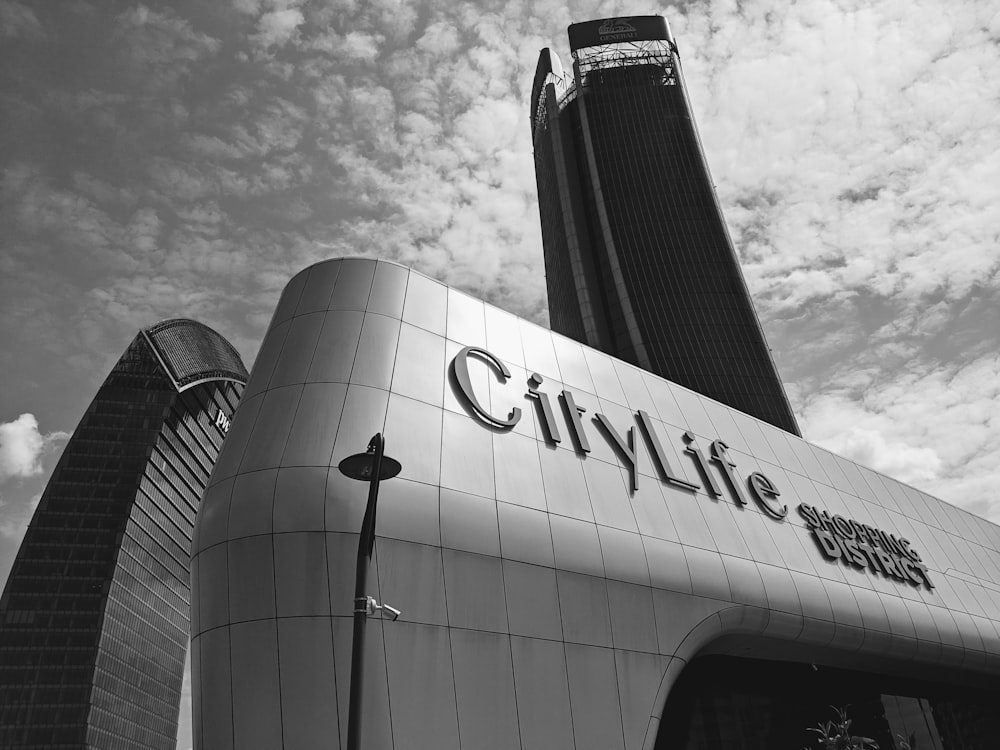 a black and white photo of a city life building