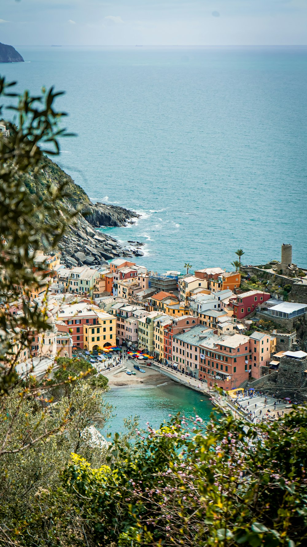 a view of a town on the shore of a body of water