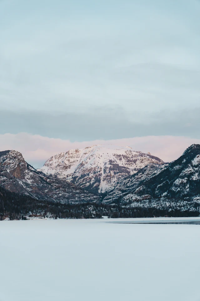 Snow-capped mountains rise above Grand Lake