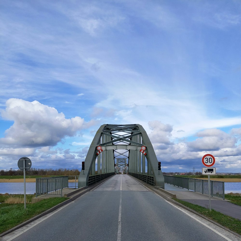 a bridge over a body of water on a cloudy day