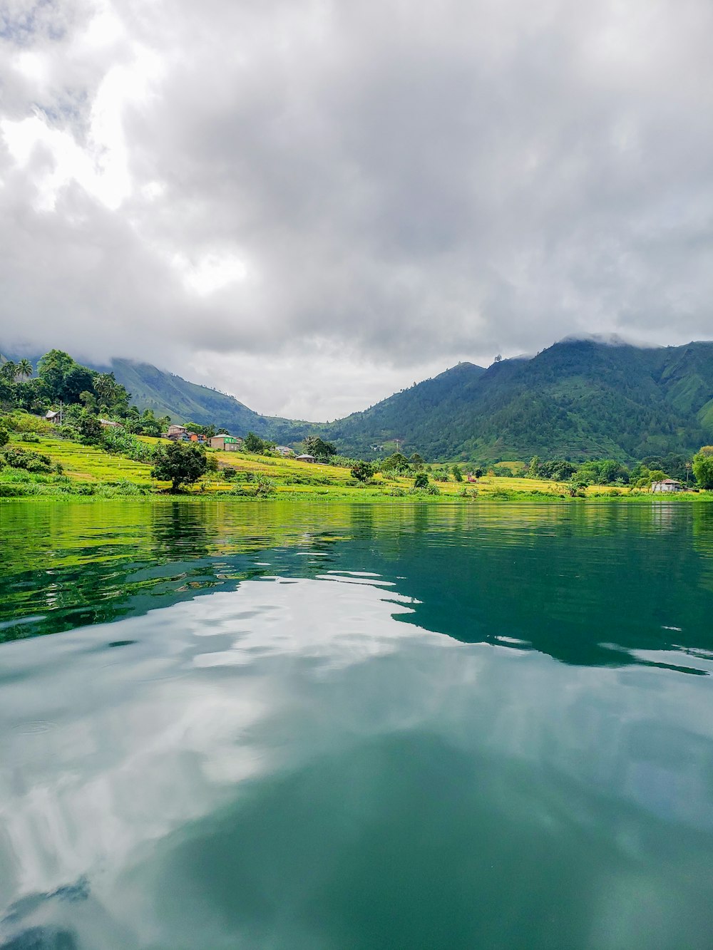 a body of water with mountains in the background