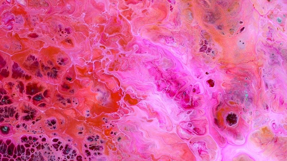 an abstract painting with pink and red colors